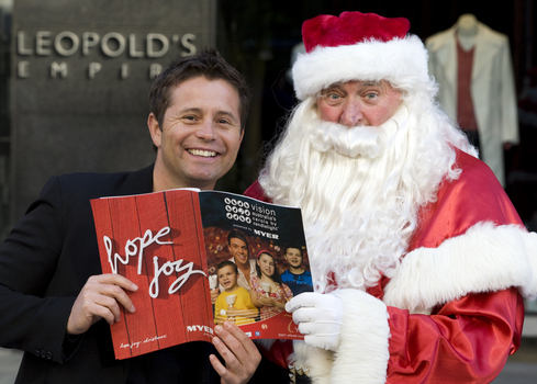 Carols launch: Steve Jacobs and Santa holding Carols program