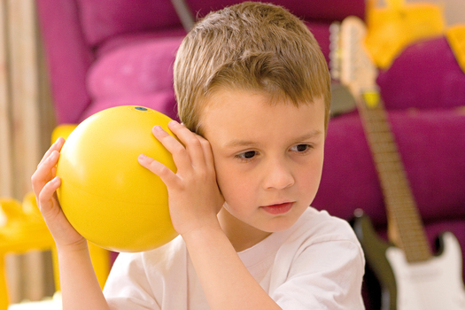 Jacob Law holding a ball with bells inside