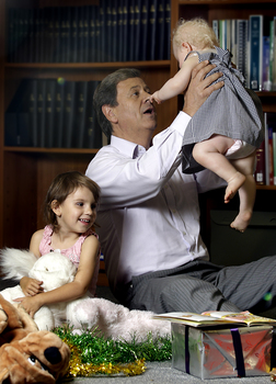 Ray Martin with two children and Christmas decorations