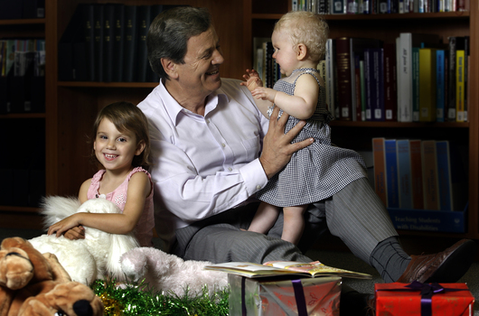 Ray Martin with two children and Christmas decorations