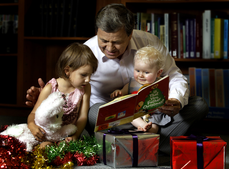 Ray Martin with two children and Christmas decorations