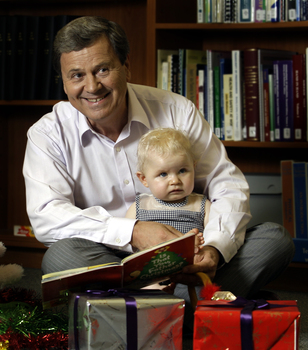 Ray Martin with two children and Christmas decorations