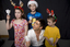 Kate, Nicholas and Jacob Law with Anthony Callea holding candles and wearing Christmas hats