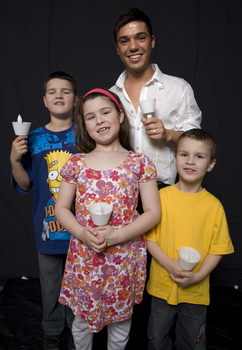 Kate, Nicholas and Jacob Law with Anthony Callea holding candles