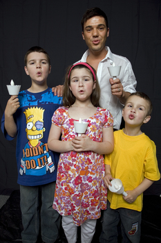 Kate, Nicholas and Jacob Law with Anthony Callea holding candles