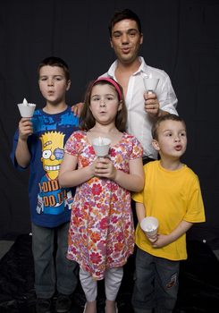 Kate, Nicholas and Jacob Law with Anthony Callea holding candles