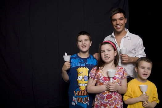 Kate, Nicholas and Jacob Law with Anthony Callea holding candles