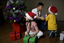 Kate, Nicholas and Jacob Law with Anthony Callea and presents under a Christmas tree