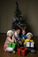 Kate, Nicholas and Jacob Law with Anthony Callea and presents under a Christmas tree