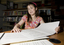 Kate Law reading a large print book in the Browsing Library