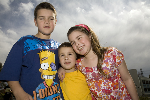 Nicholas, Jacob and Kate Law outside at Kooyong