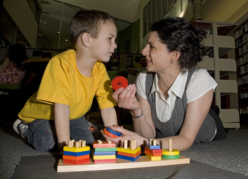 Jacob Law with a staff member and a colourful pattern sorting set