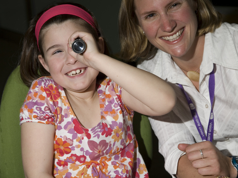 Kate Law holding a monocular telescope with Heidi Rogers