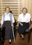 Two seated women in the Kooyong Day Centre with their walking sticks