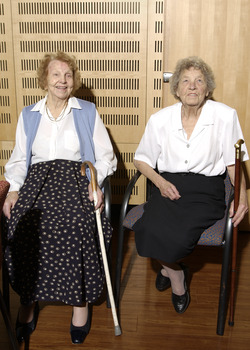 Two seated women in the Kooyong Day Centre with their walking sticks