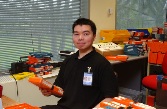Circulation Assistant Carl Sayo returning cassette books