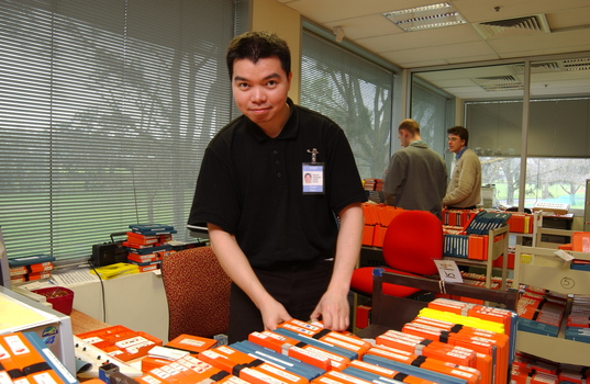 Circulation Assistant Carl Sayo returning cassette books