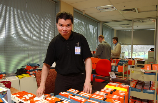 Circulation Assistant Carl Sayo returning cassette books