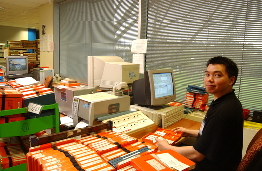 Circulation Assistant Carl Sayo returning cassette books