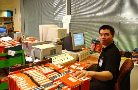 Circulation Assistant Carl Sayo returning cassette books