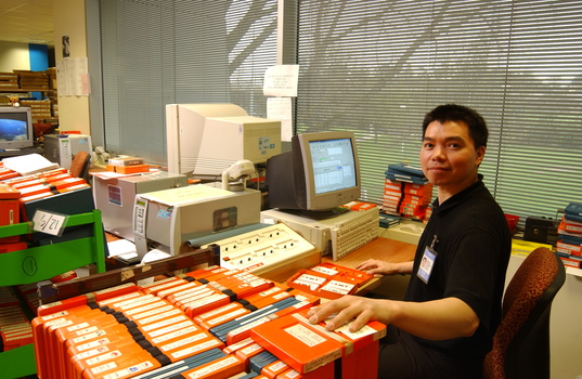 Circulation Assistant Carl Sayo returning cassette books