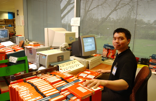 Circulation Assistant Carl Sayo returning cassette books