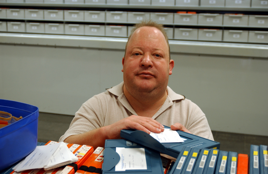 Circulation Assistant Matt carding the books for dispatch