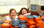 Two females hid behind a pile of cassette books