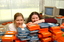 Two females hid behind a pile of cassette books