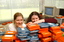 Two females hid behind a pile of cassette books
