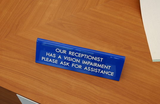 Our Receptionist has a vision impairment please ask for assistance sign