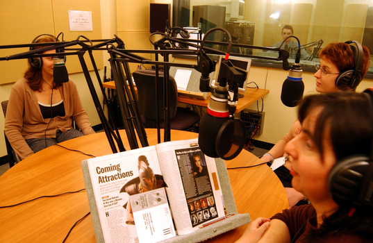 Four narrators in a recording studio, including Jean Watson