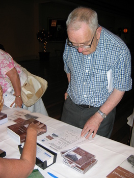 Man at book signing table