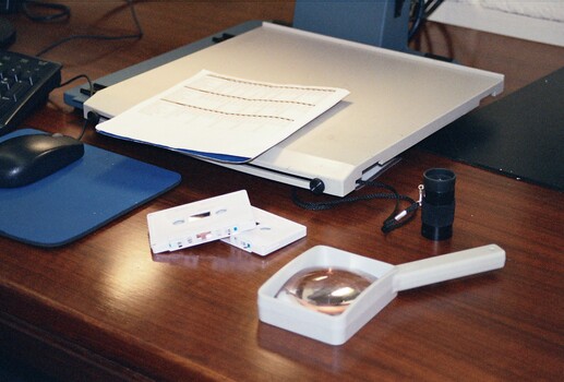 Desk with magnifiers and cassette tapes