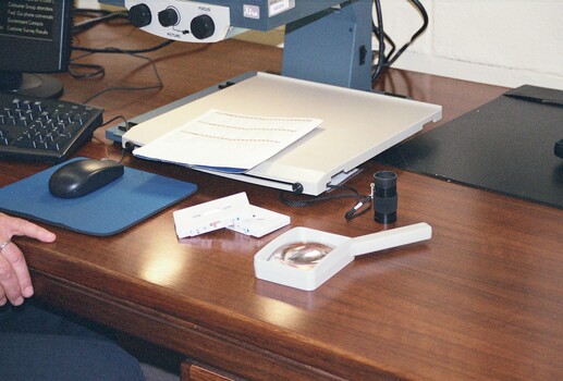 Desk with magnifiers and cassette tapes