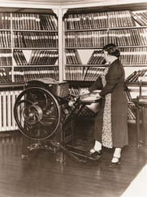 Minnie Crabb operating a Braille printing press