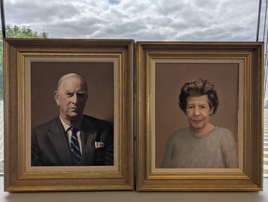 Two portraits stand side by side