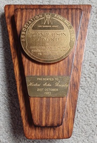 Wooden award with engraved plaque and medallion