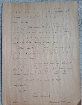 Braille letter with print handwriting above words