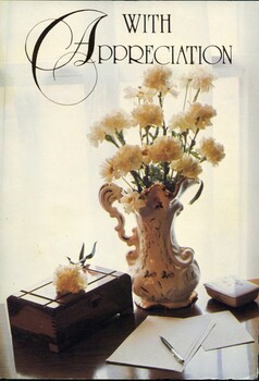 Card with image of flowers on a desk on the front