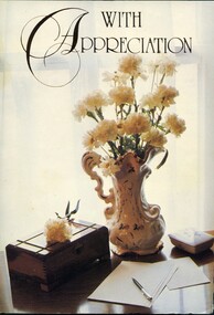 Card with image of flowers on a desk on the front