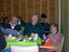 Three people sitting at table from Maryborough