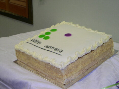 Square cake with 'v' in green and 'a' in purple Braille dots