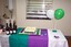 Wine and cake on green and purple tablecloths at branch launch