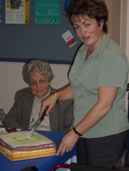 Client receiving some cake from brand launch