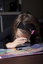 Child looking at book using magnifier