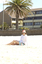Female in hat and sunglasses at beach