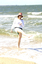 Female in hat and sunglasses at beach