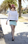 Female in hat and sunglasses at beach