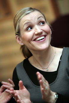 Anastasia Devaroh-Caputo clapping and smiling